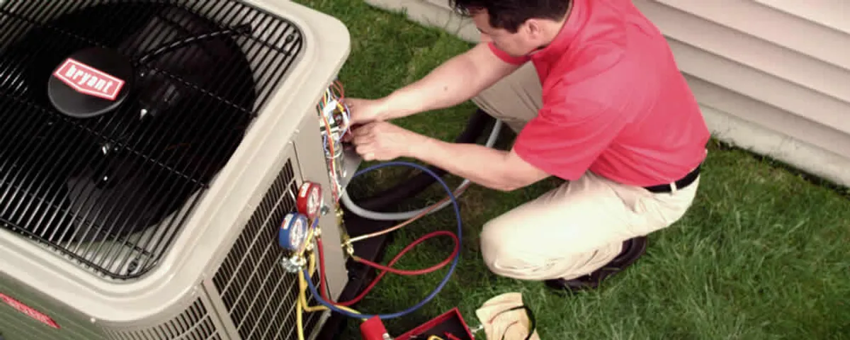 HVAC technician servicing an outdoor air conditioner unit in Tucson, AZ